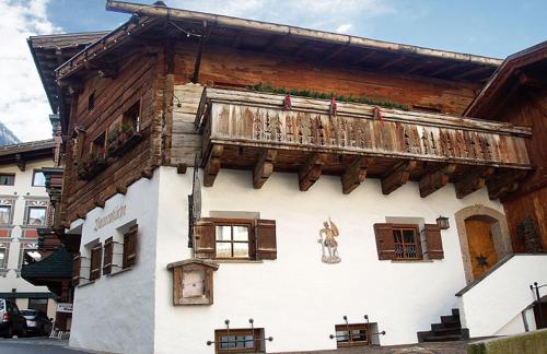 a building with a balcony on the side of it at Appartement Loba in Ischgl
