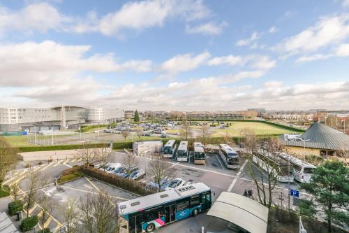 a view of a parking lot with a bus at Novotel Suites Paris CDG Airport Villepinte in Roissy-en-France