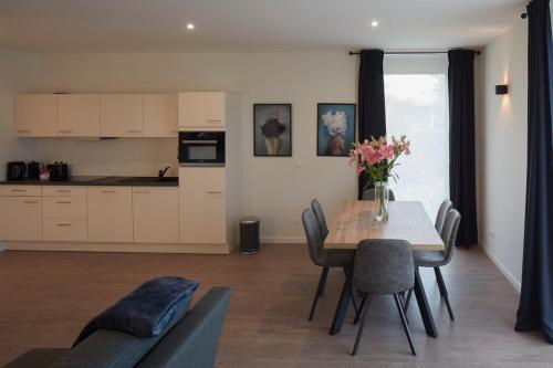 a kitchen and dining room with a table and chairs at Alpha Hotel and Aparthotel in Tienen