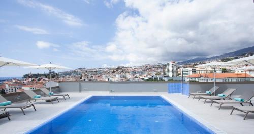 a swimming pool on the roof of a building at TURIM Santa Maria Hotel in Funchal