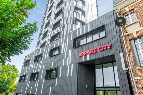 a building with a sign on the side of it at Appart'City Confort Amiens Gare in Amiens