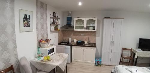 a kitchen with a table with a microwave on it at Villa Košice in Košice