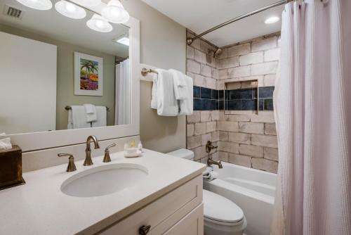 a bathroom with a sink and a toilet and a tub at Villas Of Amelia Island in Amelia Island