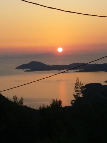 a sunset over a body of water at ΑRILLA STUDIOS in Perdika