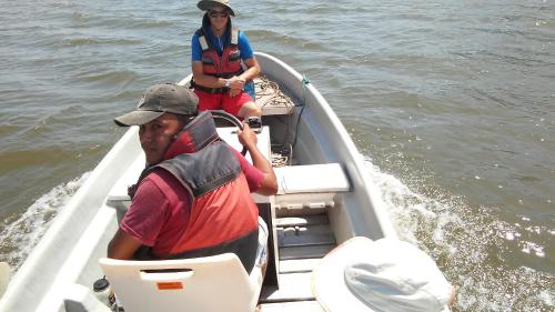 two people in a boat on the water at Caballito's Mar in Ometepe