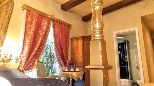 a bedroom with a bed and a large window at Rezidence Zámeček - Boutique Hotel in Františkovy Lázně