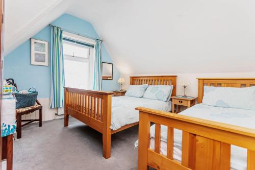 a bedroom with two beds and a window at The Ravensbourne Hotel in Bournemouth