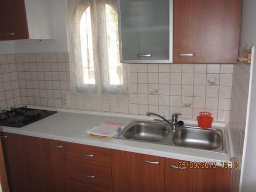 a kitchen with a sink and a counter top at Apartments Marisa in Mali Lošinj
