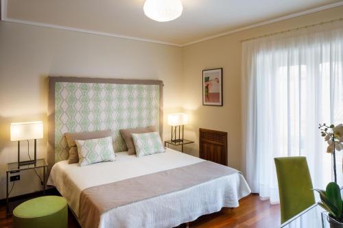 a bedroom with a bed and two chairs and a window at Villa D'Esposito - Sorrento Coast in Sant'Agnello