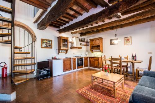 a kitchen and living room with a couch and a table at Agriturismo La Ferrozzola in Castellina in Chianti