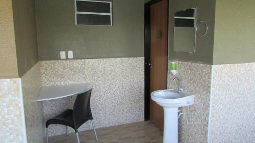 a bathroom with a sink and a toilet at Resort Hotel Atlantic City Nautico Club in Teresina