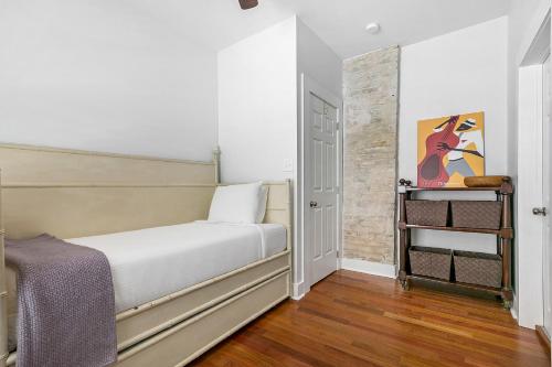 a small bedroom with a bed and a ladder at Cozy and Charming House with Luxury Amenities in New Orleans