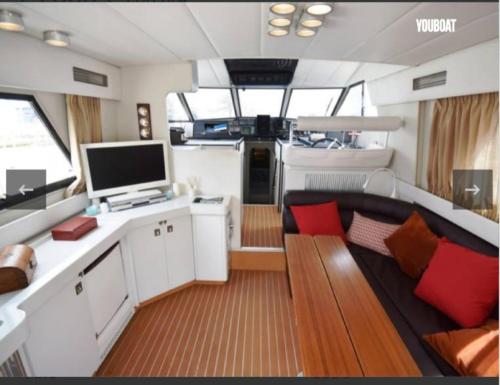 a living room with a couch and a tv on a boat at Beautiful Kiwi Boat in Barcelona