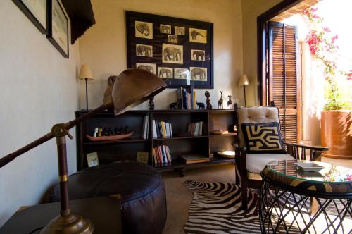 a living room with a lamp and a chair at Riad Idra in Marrakech