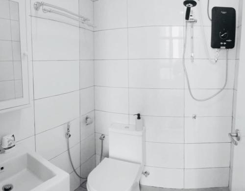 a bathroom with a shower and a toilet and a sink at Conezion IOI Putrajaya (Rustic Suite, 3 Bedrooms, 2 Baths, WiFi, Pool & City View) by MRK in Putrajaya