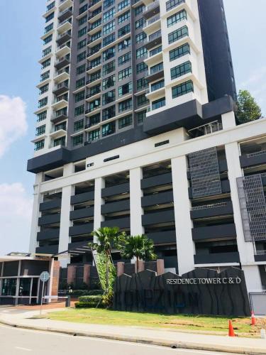 a tall building with a sign in front of it at Conezion IOI Putrajaya (Rustic Suite, 3 Bedrooms, 2 Baths, WiFi, Pool & City View) by MRK in Putrajaya