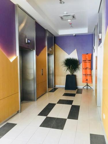 a hallway with a potted plant in a building at Conezion IOI Putrajaya (Rustic Suite, 3 Bedrooms, 2 Baths, WiFi, Pool & City View) by MRK in Putrajaya