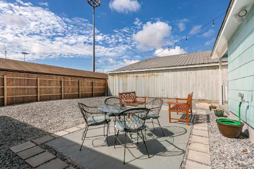 a patio with a table and chairs and a fence at Cozy and Charming House with Luxury Amenities in New Orleans