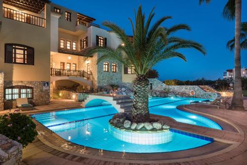 a villa with a palm tree in the middle of a swimming pool at Iason Villas – Chania, Crete in Maleme
