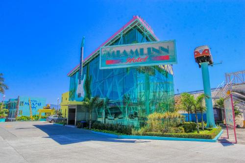 a building with a sign that reads maximillian hotel at Miami Inn in Nuevo Vallarta
