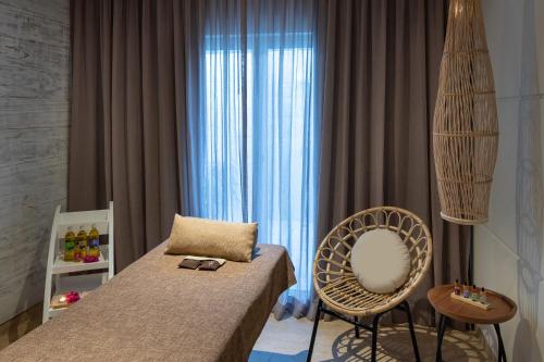 a bedroom with a bed and a chair and a window at Meliá Punta Cana Beach Wellness Inclusive - Adults only in Punta Cana
