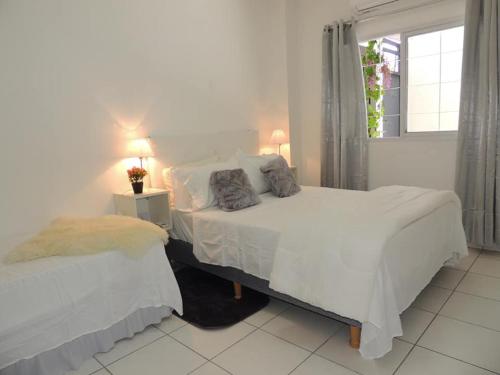Un pat sau paturi într-o cameră la Itá Apart
