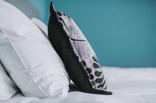 two pillows sitting on top of a bed at Bedford Hotel in Sidmouth