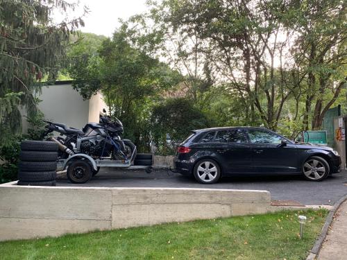 a car with a motorcycle parked next to it at Classic Driver Home 1 in Royat