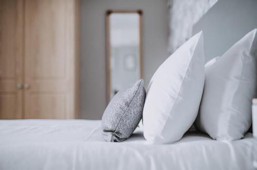 a white bed with white pillows on it at Bedford Hotel in Sidmouth