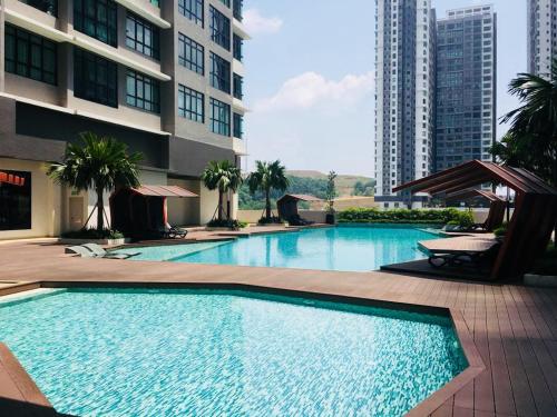 a large swimming pool in the middle of a building at Conezion IOI Putrajaya (Rustic Suite, 3 Bedrooms, 2 Baths, WiFi, Pool & City View) by MRK in Putrajaya