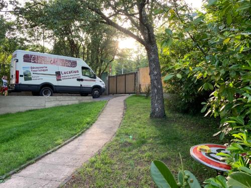 a white van parked in a yard next to a driveway at Classic Driver Home 1 in Royat