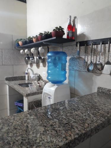 a kitchen with a counter with a blue container on it at Sótão Oktoberfest in Blumenau