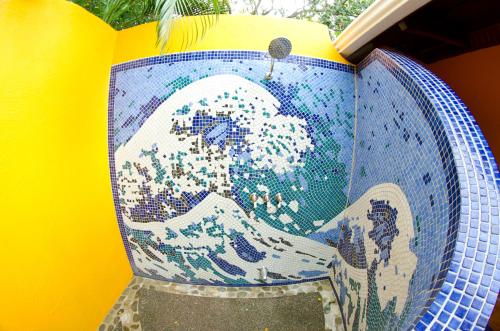 a vase with a painting of a wave on it at Hotel Vista de Olas in Santa Teresa Beach