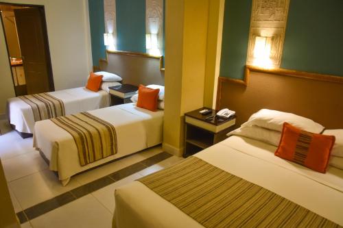 Un pat sau paturi într-o cameră la Hotel Inkai