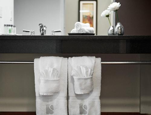 two white towels on a towel rack in a bathroom at Samuels Boutique Hotel in Goderich