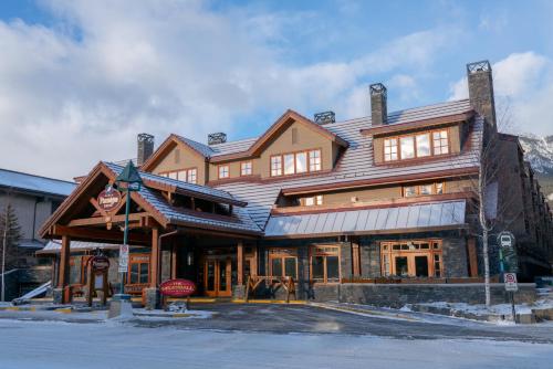 a large wooden building in the middle of a street at Banff Ptarmigan Inn in Banff