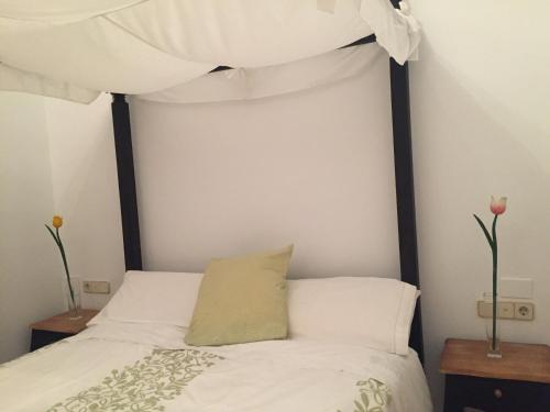 a bedroom with a bed with a canopy at Casa Modernista "La Trinidad" in Sagunto