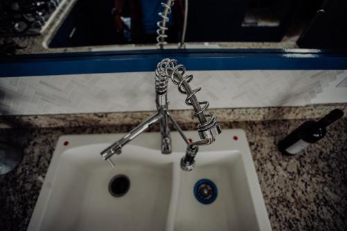 a white sink with a chain on a counter at Trojan House in Ensenada