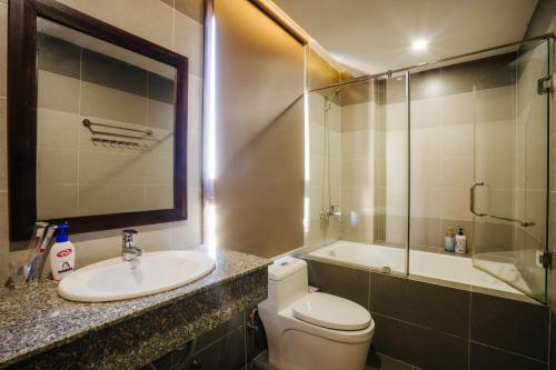a bathroom with a sink and a toilet and a shower at Hoi An Lotus Aroma Villa in Hoi An