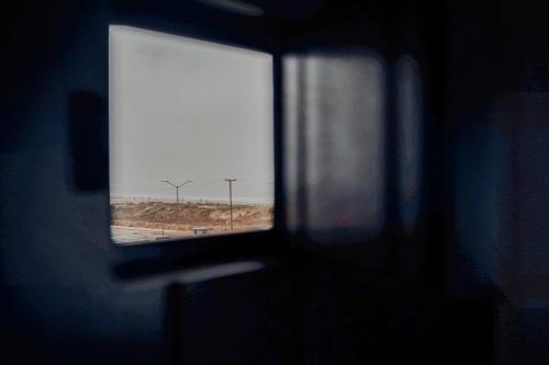 a window in a room with a view of a field at Trojan House in Ensenada