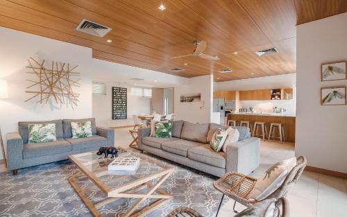 a living room with two couches and a table at Noosa Residences in Noosa Heads