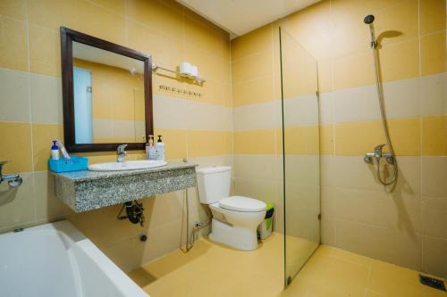 a bathroom with a toilet and a sink and a shower at Hoi An Lotus Aroma Villa in Hoi An