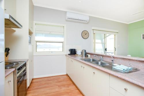 a kitchen with a sink and a counter top at Salt - Aldinga Beach - C21 SouthCoast Holidays in Aldinga Beach
