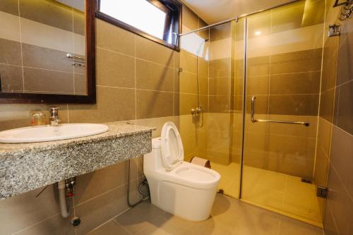 a bathroom with a toilet and a sink and a shower at Hoi An Lotus Aroma Villa in Hoi An