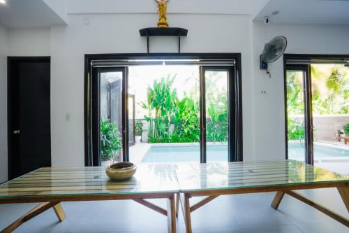 a table in a room with a view of a pool at Hoi An Lotus Aroma Villa in Hoi An