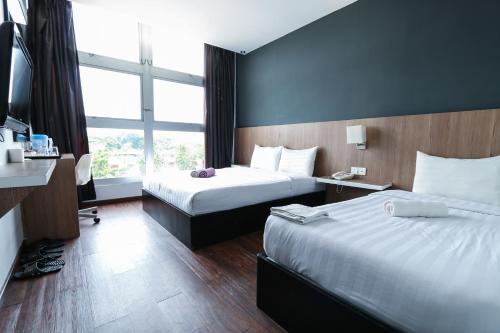 Postel nebo postele na pokoji v ubytování Hotel 99 Botanik Klang