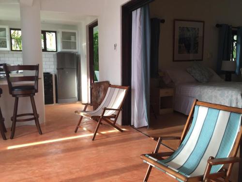 a living room with two chairs and a bed at Casa Doro Villa in Glacis
