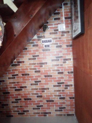 a brick wall with a sign that reads garage wife at Ban Kru Ae mixed dorm in Ban Don Muang
