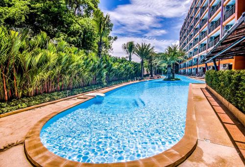 a swimming pool in the middle of a building at MBC Mai Khao Beach Condotel LUXURY APARTMENTs in Phuket