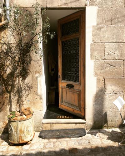 an entrance to a building with a wooden door at Studio du Cherche Midi in Jarnac